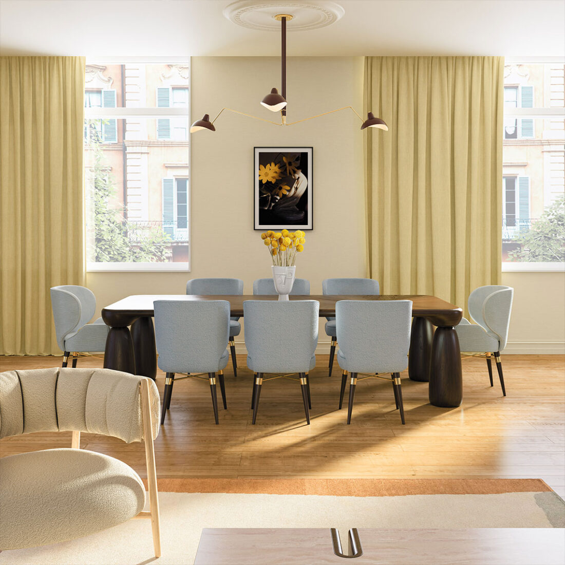 Louis dining chair upholstered in soft blue fabric with a smoked walnut wood frame, set in a dining room with pale yellow tones. The space also features a Mansfield dining table and a Chelsea suspension lamp in a deep red hue. To the front and slightly to the side, an Ellen armchair adds a touch of elegance.