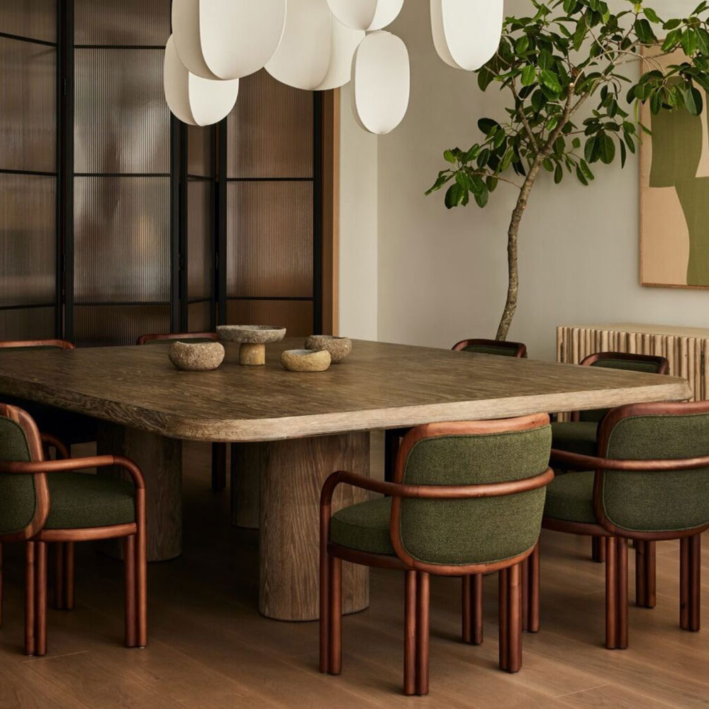 New York’s Soho loft dining room featuring James dining chairs in dark green and smoked walnut wood, interior by Studio Michael Ellison.