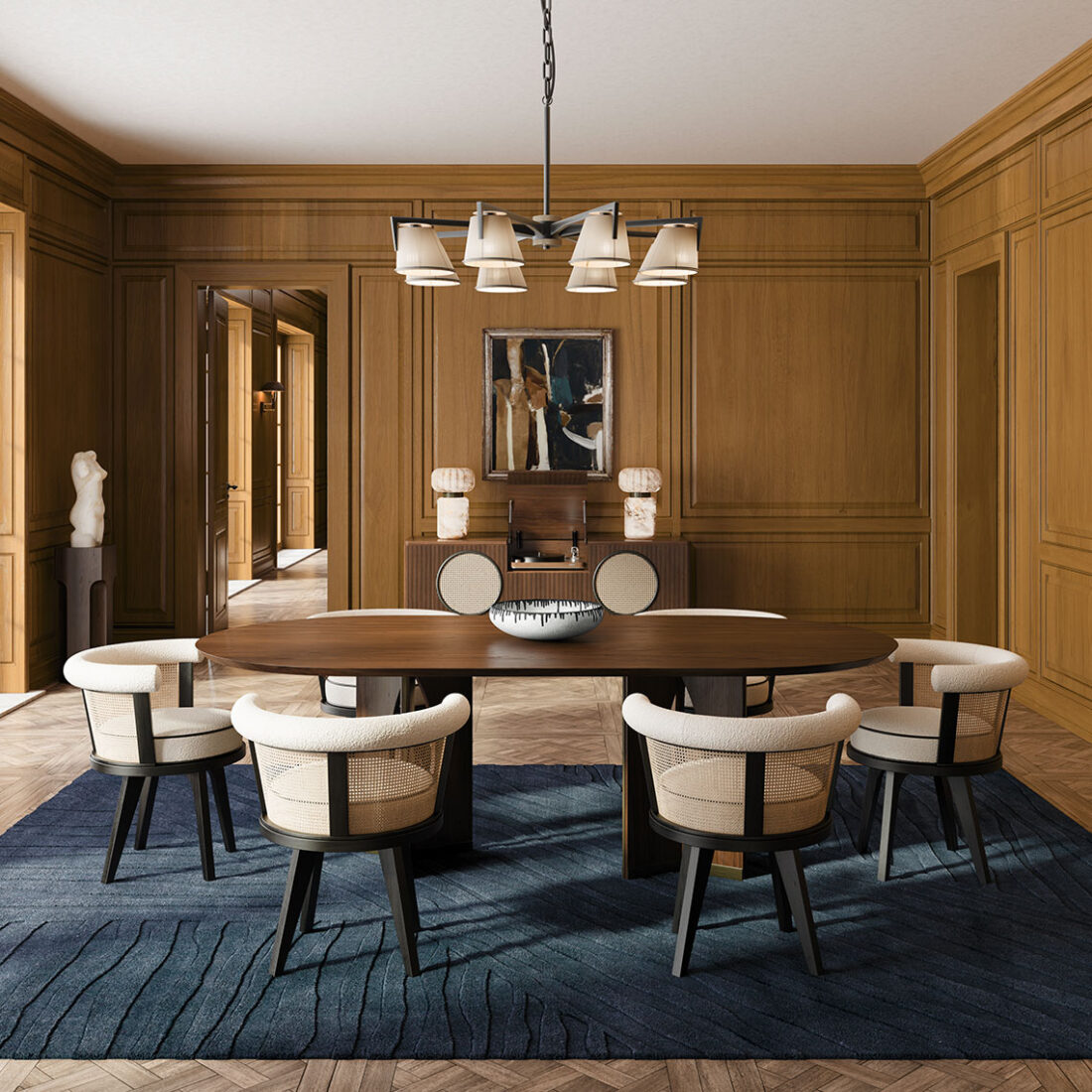 George dining chair featuring black stained ashwood and natural rattan, set in a dining room alongside the Taylor dining table in smoked walnut wood with brass details. The scene also includes the Harrison sideboard, Hampshire table lamp in alabaster, and Santos suspension lamp.