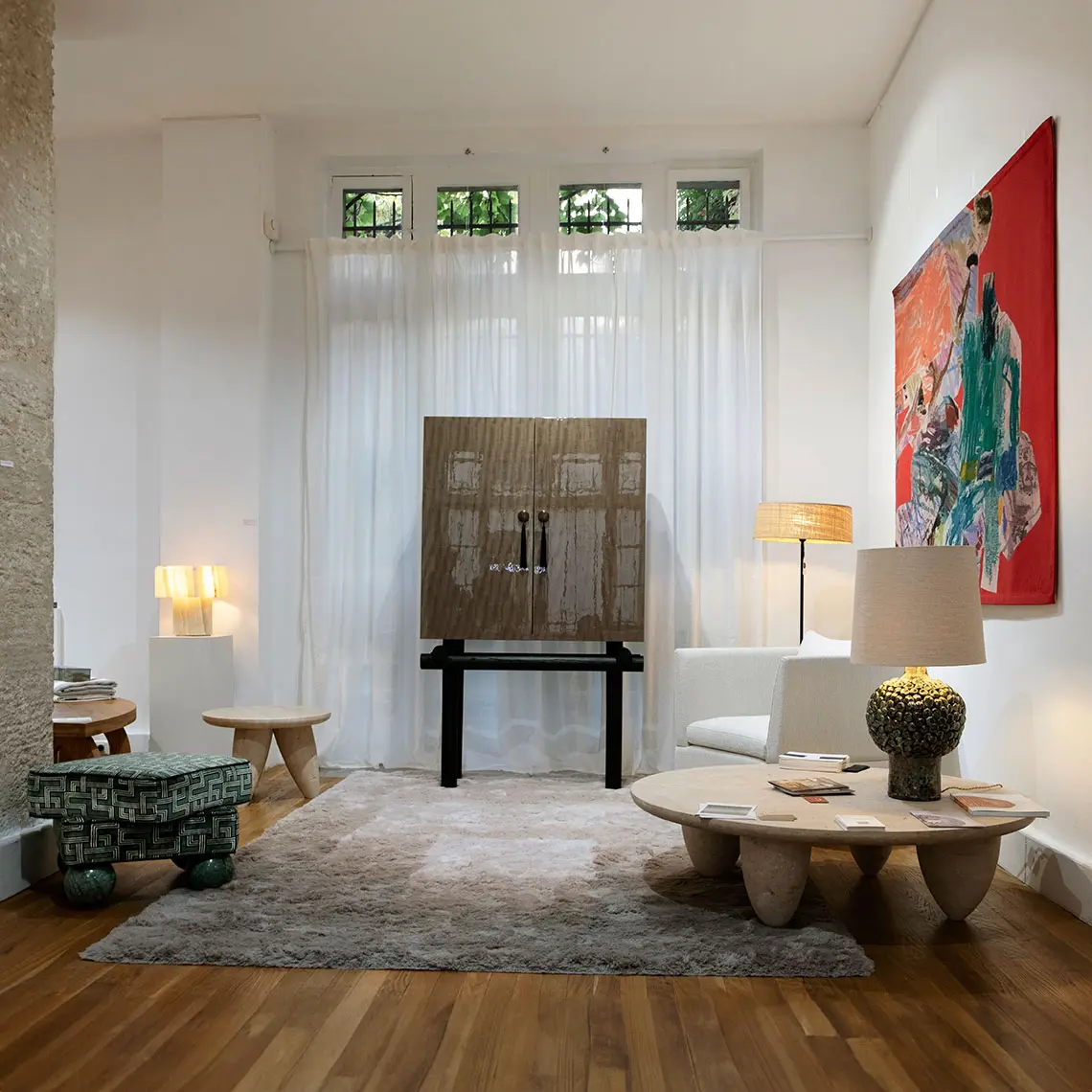 Madonna stool in the living room at Paris Design Week 2024, featuring green velvet and Verde Guatemala marble.