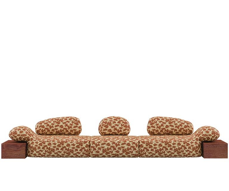 Viv Id II sofa upholstered in Dedar fabric with an orange pattern, paired with Travertino Rosso.