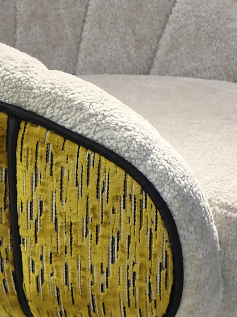 Vivien Swivel Bar Chair Detail of the Vivien Swivel Bar Chair showcasing fur-like beige fabric paired with yellow velvet featuring black stripes