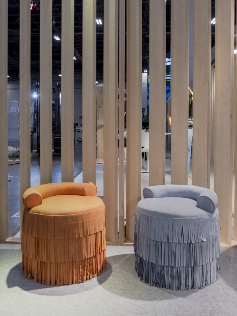 Beth Stools Two Beth Stools, one upholstered in orange suede and the other in blue, both featuring decorative fringes