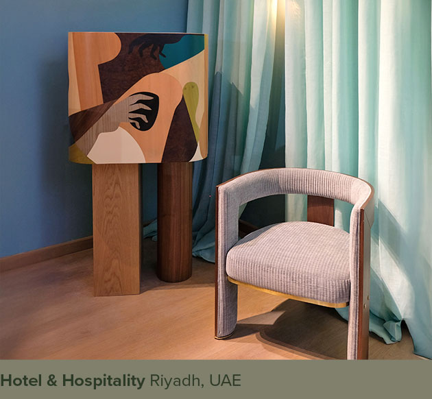 Ih Maj In cabinet with marquetry placed beside a Brooklyn dining chair upholstered in blue fabric, showcased at Hotel & Hospitality Riyadh.