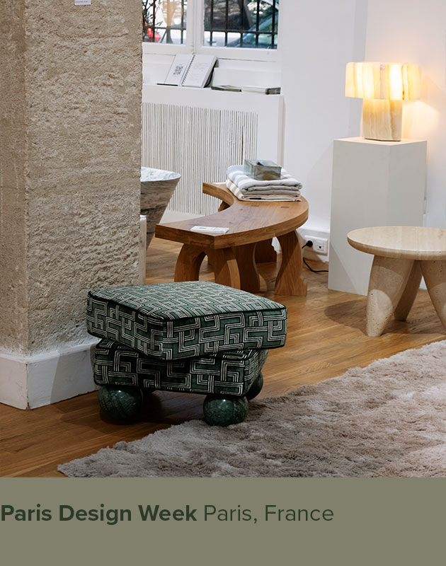 Madonna Stool upholstered in patterned green fabric with a Verde Guatemala marble feet, showcased at Paris Design Week.