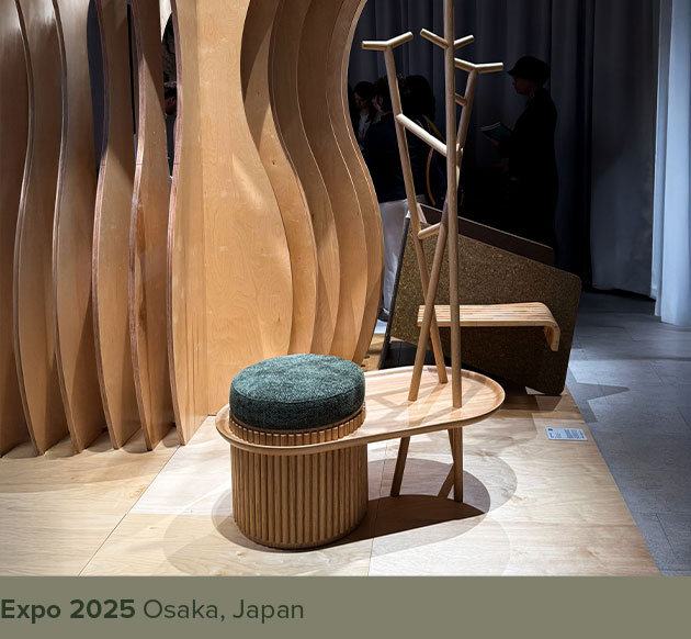 Barlow Coat Hanger in oak wood paired with green upholstery, displayed at Expo 2025 in Osaka, Japan.